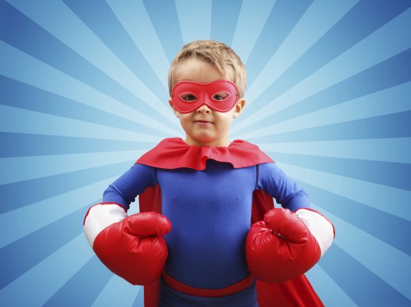 Superhero child with boxing gloves