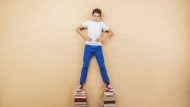 Boy standing on books