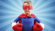 Superhero child with boxing gloves